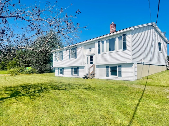 rear view of house with a yard