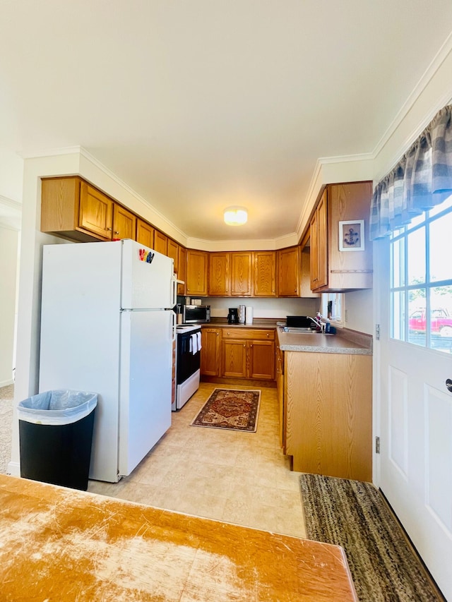 kitchen featuring light tile flooring, white appliances, and sink