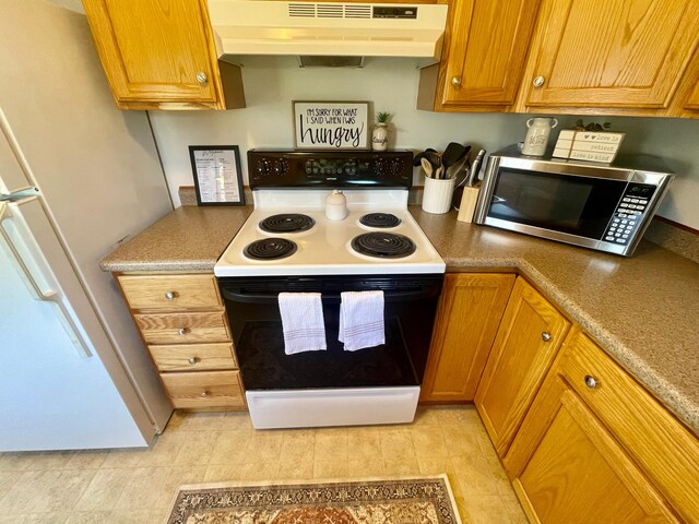 kitchen with white appliances, custom range hood, and light tile floors