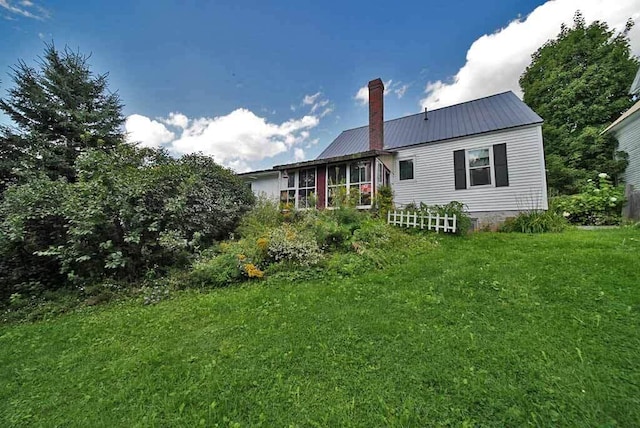 back of house featuring a yard