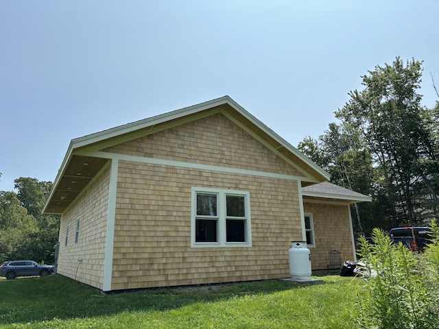 view of side of home with a yard