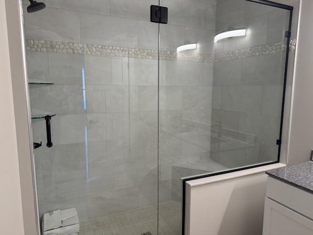 full bathroom featuring a shower stall and vanity