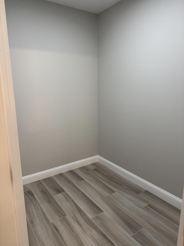 spare room featuring light wood-style flooring and baseboards