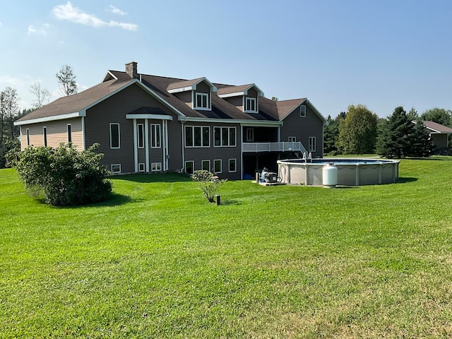 rear view of house featuring a yard