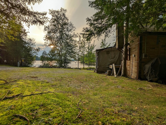 32 N Mud Cove Rd, Lily Bay Twp, ME 04441 - yard at dusk with a water view and a shed