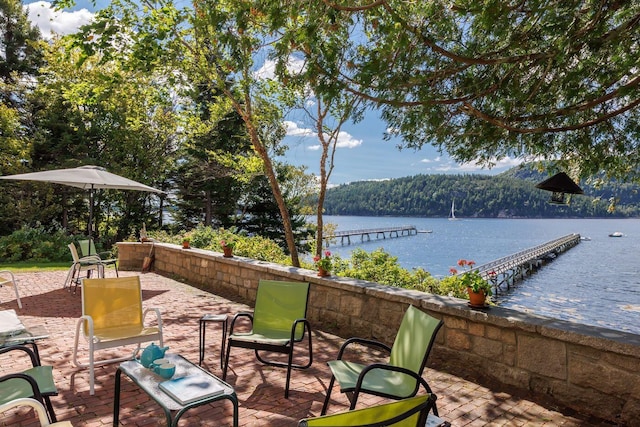 view of terrace with a water view