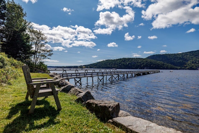 view of dock featuring a water and mountain view