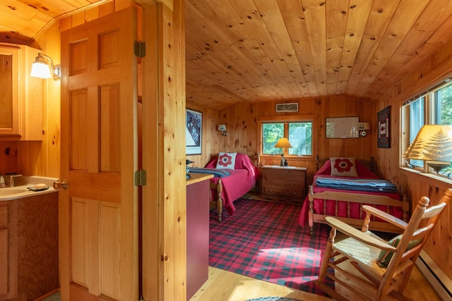 228 Starbird Ln, Rome, ME 04963 - bedroom with lofted ceiling, a baseboard heating unit, multiple windows, wooden walls, and wooden ceiling