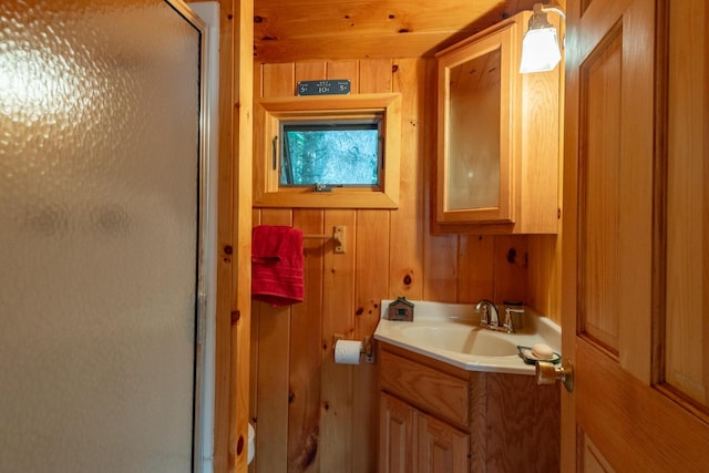 228 Starbird Ln, Rome, ME 04963 - full bathroom with a shower stall, vanity, and wooden walls