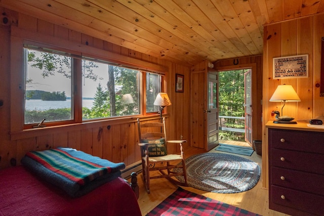 228 Starbird Ln, Rome, ME 04963 - bedroom with wooden walls, multiple windows, wood finished floors, wood ceiling, and lofted ceiling