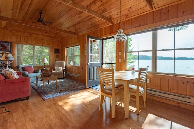 228 Starbird Ln, Rome, ME 04963 - dining room with wooden ceiling, wooden walls, a baseboard radiator, wood finished floors, and ceiling fan