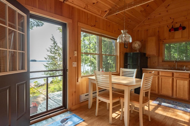228 Starbird Ln, Rome, ME 04963 - dining room with wood ceiling, a baseboard heating unit, light wood finished floors, vaulted ceiling, and wooden walls