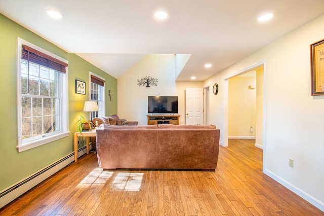 living area with baseboards, light wood-type flooring, baseboard heating, and recessed lighting