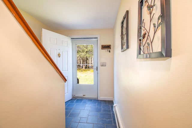 entryway featuring a baseboard radiator, baseboards, and stone finish floor