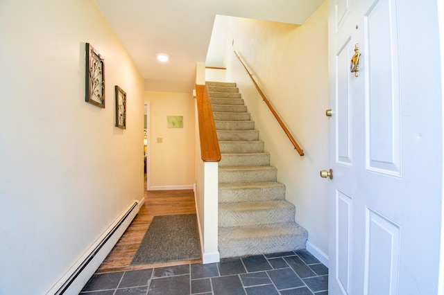 staircase featuring baseboards, baseboard heating, and recessed lighting
