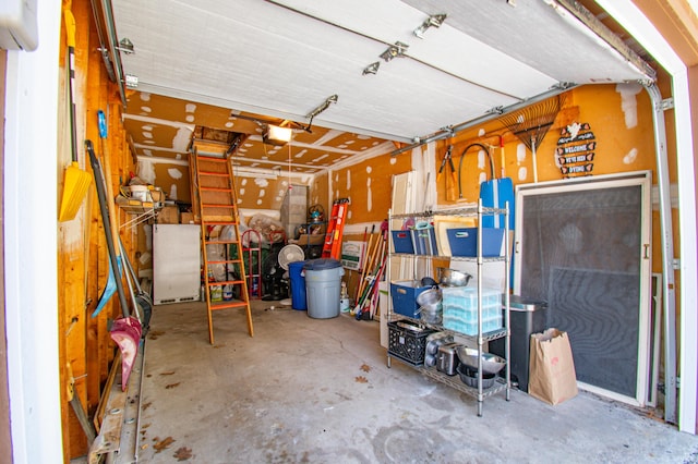 garage featuring refrigerator and a garage door opener