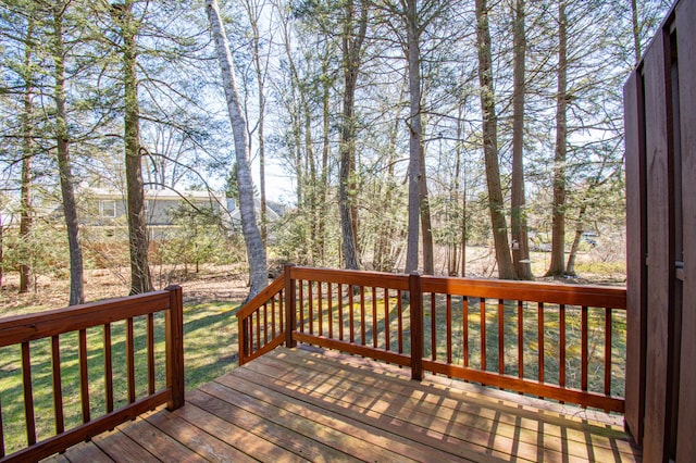 wooden terrace with a lawn