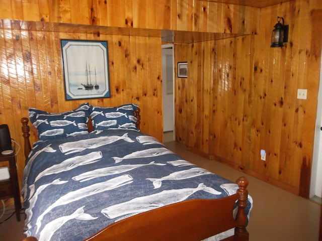 bedroom featuring wooden walls