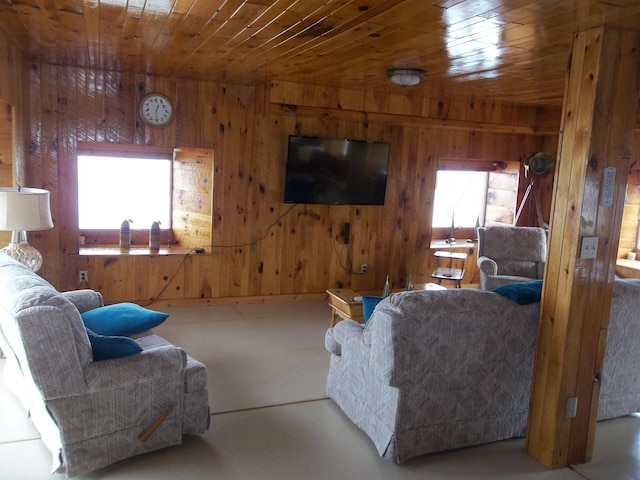 living room featuring wooden ceiling and wood walls