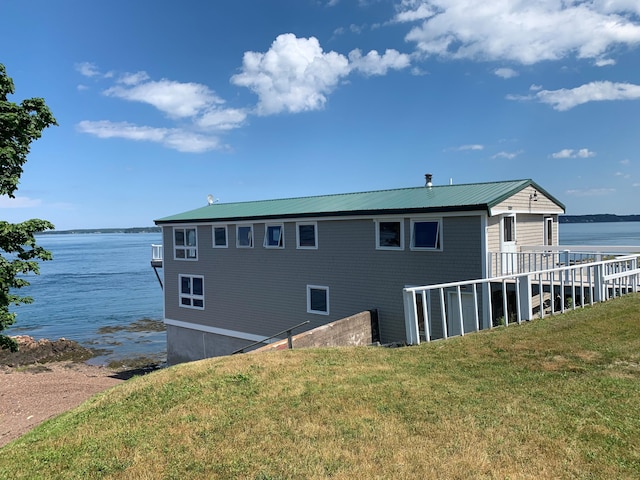 exterior space featuring a water view and a yard