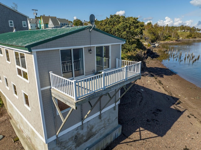 back of house with a deck with water view