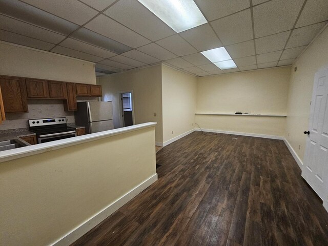 55 Cony St, Augusta, ME 04330 - kitchen with appliances with stainless steel finishes, dark wood finished floors, brown cabinets, a drop ceiling, and baseboards