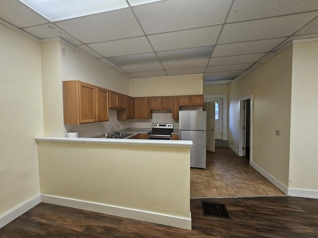 55 Cony St, Augusta, ME 04330 - kitchen featuring appliances with stainless steel finishes, a drop ceiling, a peninsula, baseboards, and dark wood-style floors