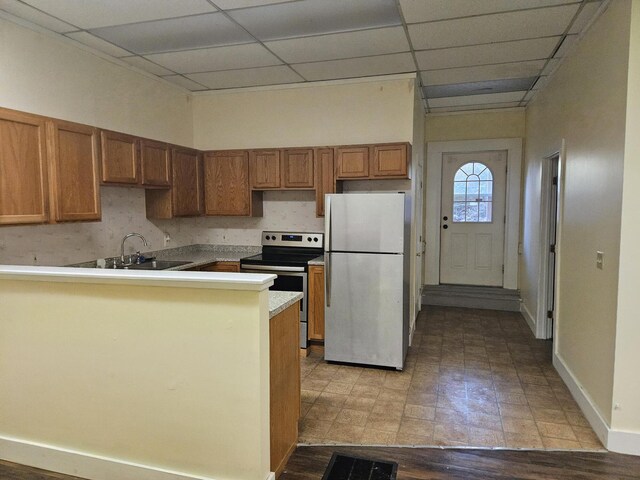 55 Cony St, Augusta, ME 04330 - kitchen with appliances with stainless steel finishes, a sink, brown cabinets, a paneled ceiling, and baseboards