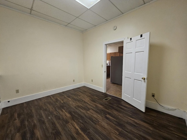 55 Cony St, Augusta, ME 04330 - empty room with a paneled ceiling, dark wood-type flooring, and baseboards