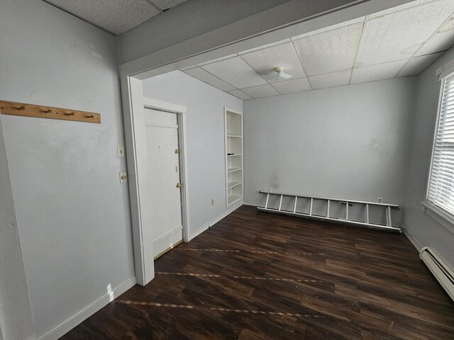 55 Cony St, Augusta, ME 04330 - unfurnished room with a drop ceiling, a baseboard radiator, wood finished floors, and baseboards