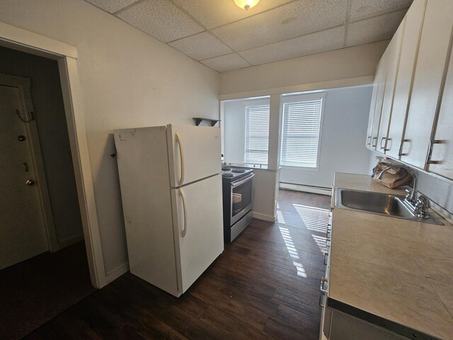 55 Cony St, Augusta, ME 04330 - kitchen with stainless steel range with electric cooktop, a paneled ceiling, freestanding refrigerator, a sink, and a baseboard radiator