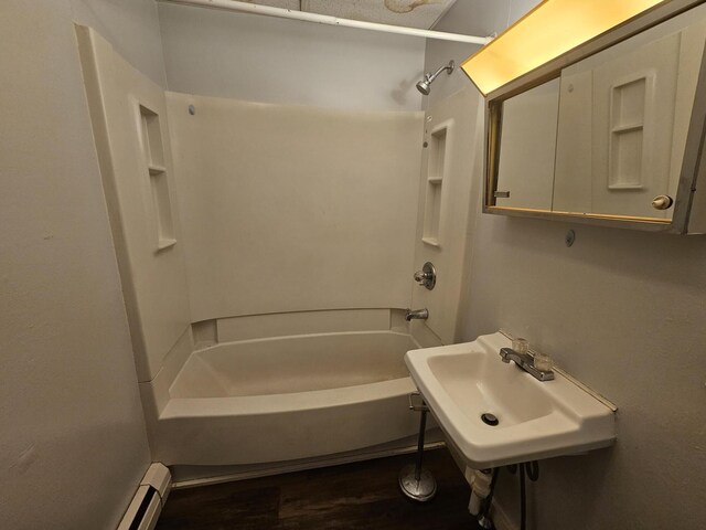 55 Cony St, Augusta, ME 04330 - full bathroom featuring wood finished floors, shower / tub combination, a sink, and baseboard heating