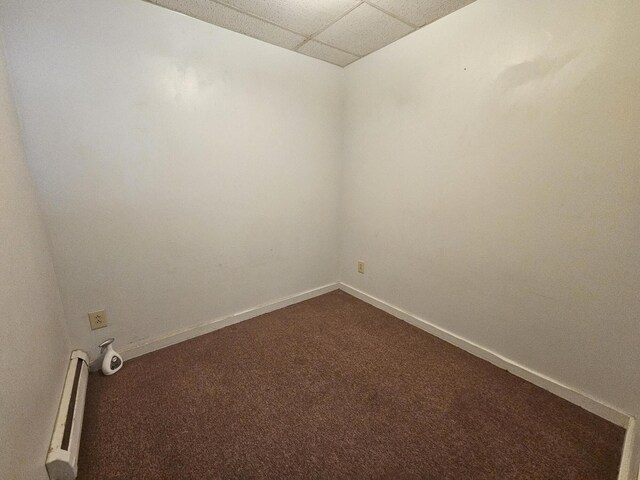 55 Cony St, Augusta, ME 04330 - unfurnished room with a paneled ceiling, dark colored carpet, baseboard heating, and baseboards