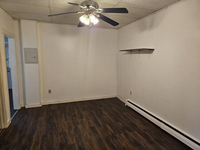 55 Cony St, Augusta, ME 04330 - empty room with a baseboard radiator, a drop ceiling, ceiling fan, dark wood-style floors, and electric panel