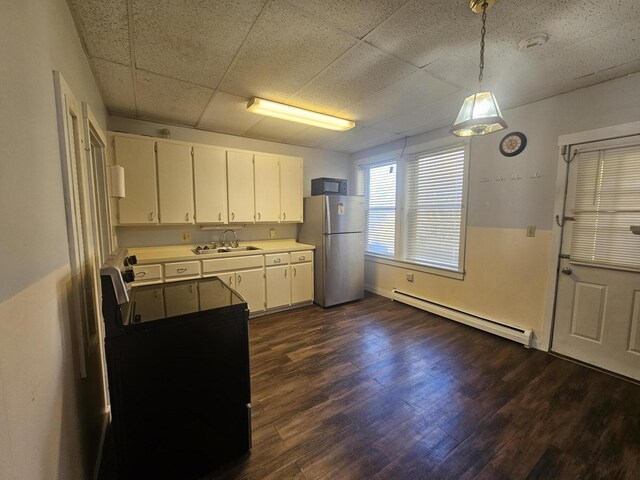 55 Cony St, Augusta, ME 04330 - kitchen with a baseboard heating unit, freestanding refrigerator, a sink, light countertops, and white cabinetry