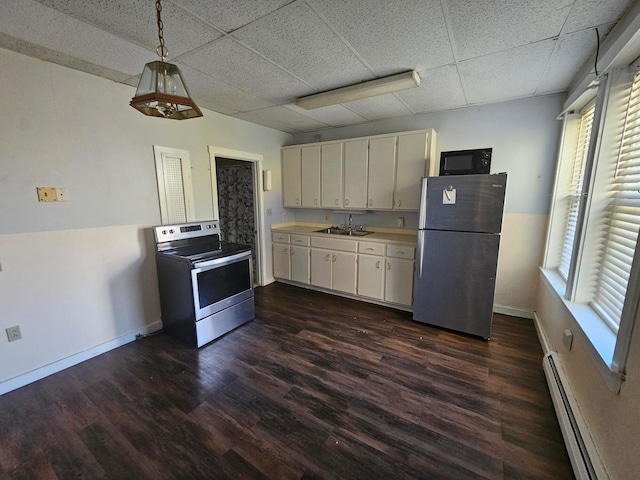 kitchen with decorative light fixtures, a baseboard radiator, appliances with stainless steel finishes, a paneled ceiling, and dark hardwood / wood-style flooring