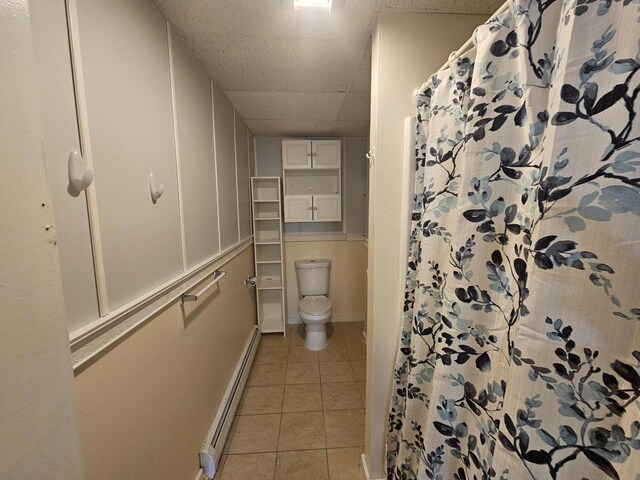 55 Cony St, Augusta, ME 04330 - full bath featuring a baseboard radiator, tile patterned floors, baseboards, toilet, and a paneled ceiling