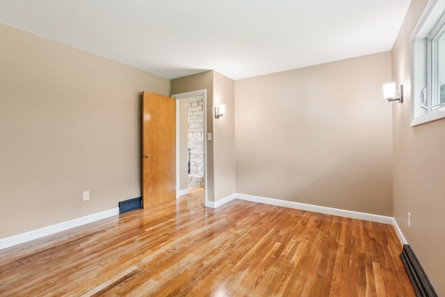 7 Alweber Rd, Windham, ME 04062 - spare room featuring light wood-style flooring, baseboards, and a baseboard radiator