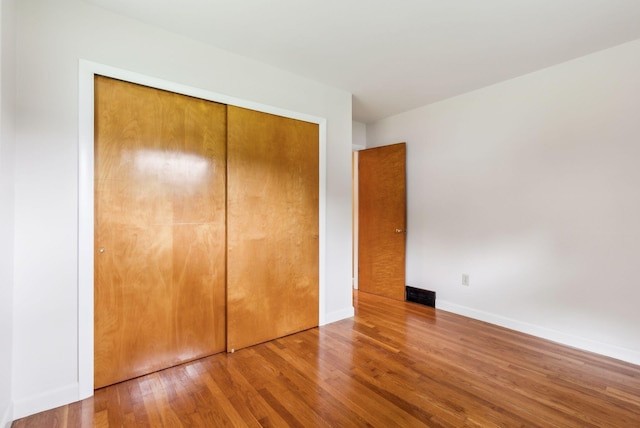 7 Alweber Rd, Windham, ME 04062 - unfurnished bedroom with wood finished floors, a closet, and baseboards