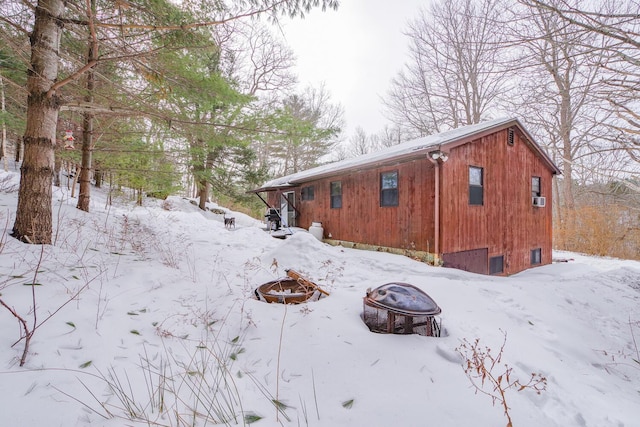 view of snow covered exterior featuring an outdoor fire pit