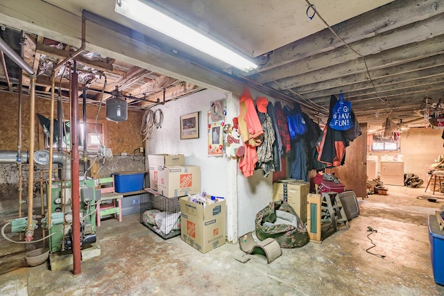 unfinished basement featuring washing machine and clothes dryer