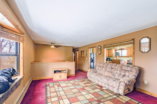 living room featuring baseboards, dark carpet, baseboard heating, and a ceiling fan