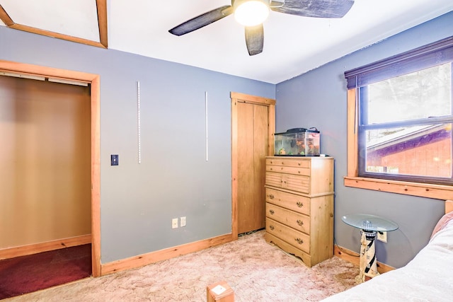 bedroom with light carpet, ceiling fan, and baseboards