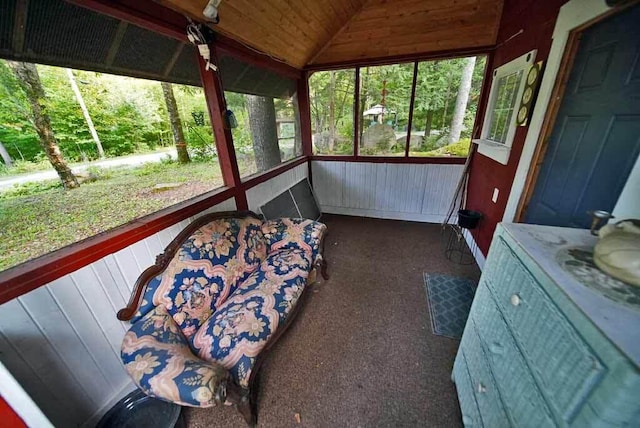 sunroom / solarium featuring wood ceiling and lofted ceiling