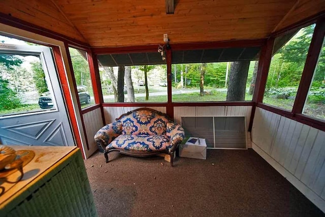 unfurnished sunroom with a healthy amount of sunlight, vaulted ceiling, and wood ceiling