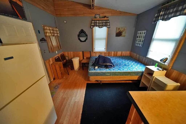 bedroom featuring lofted ceiling and hardwood / wood-style floors