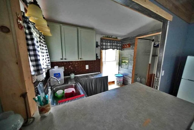 kitchen featuring white cabinetry and sink