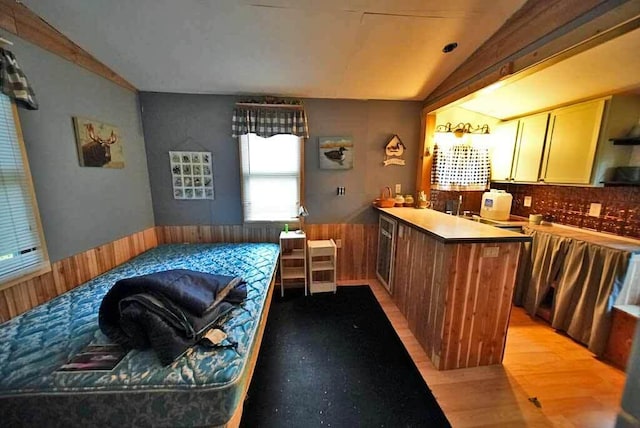 interior space with lofted ceiling, light wood-type flooring, and wine cooler