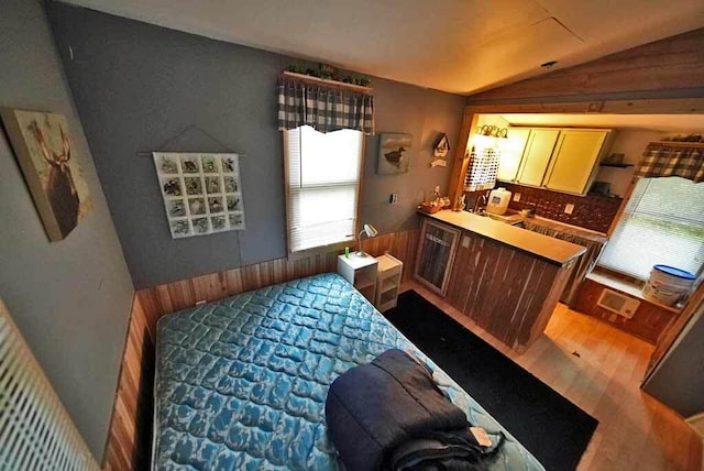 bedroom featuring lofted ceiling and dark hardwood / wood-style floors