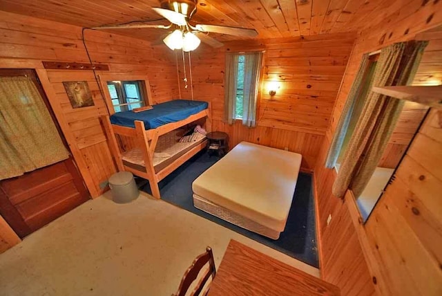 bedroom with wood walls and wooden ceiling